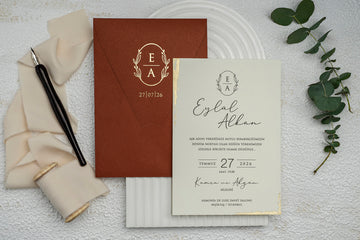Rust-Colored Wedding Invitation with Gold Crest and Foil Edge