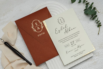 Rust-Colored Wedding Invitation with Gold Crest and Foil Edge
